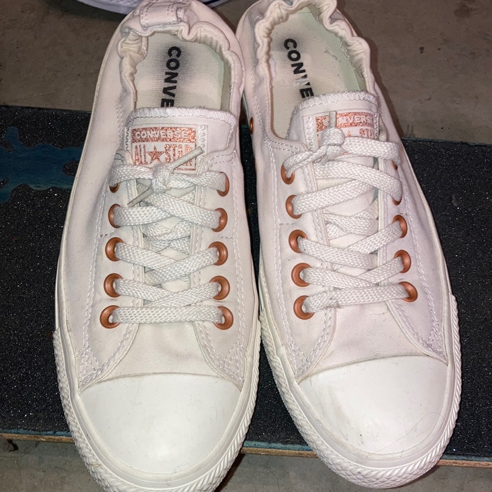 Woman’s 11 white converse.